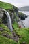 Traveler near Skardsafossur waterfall on Vagar island, Faroe Islands
