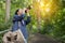 Traveler with a photo camera in hand outdoor in the forest