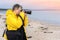 Traveler photographer on beach shooting photo of sea