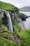 Traveler photographs the Skardsafossur waterfall on Vagar island, Faroe Islands