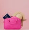 Traveler pink suitcase and passport document,purse on pink background, Journey and travel concept