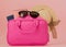 Traveler pink suitcase and passport document,purse on pink background, Journey and travel concept