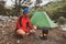 Traveler relaxes in the mountains among lush pines