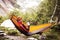 Traveler relaxing in hammock in the mountains