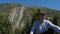 Traveler resting in Tian Shan mountains and looking at camera