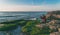 Traveler on a rocky seashore overgrown with green algae taking pictures