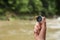 Traveler searching direction with compass in wilderness, closeup