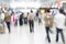 Traveler silhouettes in motion blur, airport interior