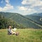 Traveler sitting on the alpine meadow