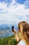 Traveler smartphone, landscape photography. Attractive girl takes story on smartphone while traveling mountains in Montenegro.