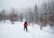 Traveler with snowshoes at snow forest in the mountains