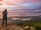 Traveler stand on Rocky cilff with sunsire sky and beautiful cloud sea on `Pa na rai` Khao Luang mountian