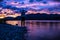 Traveler standing on shore with colorful sunset sky