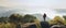 traveler standing at stone for look at view on top mountain