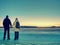 Traveler stay on ice of frozen sea. Woman with backpack