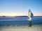 Traveler stay on ice of frozen sea. Woman with backpack