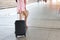 Traveler suitcase, Young asian business woman or traveler in pink casual dress carrying a black suitcase walking in a travel