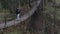 traveler on a suspension bridge in forest wild extreme journey