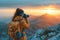 Traveler taking a picture of sunset on the mountain peak