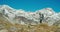 Traveler on tourist path with hiker backpack enjoying epic mountain landscape