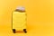 Traveler tourist suitcase trunk luggage bag with summer straw hat isolated on yellow orange background. Passenger things