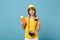 Traveler tourist woman in yellow clothes hat hold tickets credit card camera isolated on blue background. Female