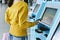 Traveler using a self check-in machine kiosk service at airport.