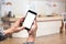 Traveler using smartphone at check-in information in front of the hotel reception desk