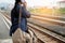 Traveler is waiting for train at the railway station. Women using smartphone for waiting train station platform