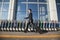 Traveler walking fast next to row of luggage carts at airport