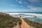 Traveler walks on a sandy path during a sunny day in Odemira region, western Portugal. Wandering along the Fisherman Trail, Rota