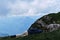 Traveler was tired in campaign and decided to rest. Male tourist fell asleep in grass on top of mountain against the background of