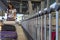 Traveler woman in airport terminal using mobile smartphone with luggage and bag on airport trolley cart.Young asian girl tourist