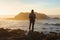 Traveler woman with backpack enjoying ocean view, girl hiker at sunset, travel concept, California, USA