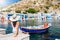 Traveler woman enjoys the view to the fishing village of Klima on the island of Milos