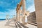 traveler woman with greek flag at the ancient greek ruins. Tourism in Greece concept