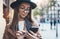 Traveler woman in hat hold in hands mobile phone. Closeup smartphone technology internet online. Girl tourist in glasses using