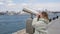 Traveler woman looking city panorama by tourist binoculars to Bosporus strait in Istanbul, Turkey. Tourist woman looking