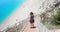 Traveler woman walking down new stairs at Egremni beach, Lefkada Greece.