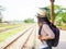 Traveler woman walking and waits train on the railway platform.