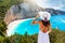 A traveler woman in white dress enjoys the view to the popular beach of Porto Katsiki, Lefkada