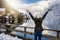 A traveler woman in winter clothing enjoys the view to the village of Hallstatt in the Austrian Alps