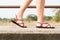 Traveler young women on sneakers shoe walking on the bridge on sunny day