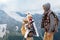 Travelers drinking tea in thermos in mountains