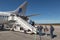 Travelers entering an airplane ready for departure at Eindhoven airport