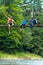 Travelers, friends sit on the suspension bridge