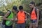 Travelers, hikers on vacation reading a map. Two young Tourists With Backpacks travel. Three young Tourists With Backpacks travel