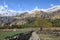 Travelers hiking through rice fields and snowy mountains at the background