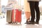 Travelers legs and suitcases in a travel location