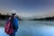 Travelers looking at the lake and pine forest on morning time at